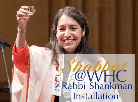 Rabbi Shankman raises a small cup of wine