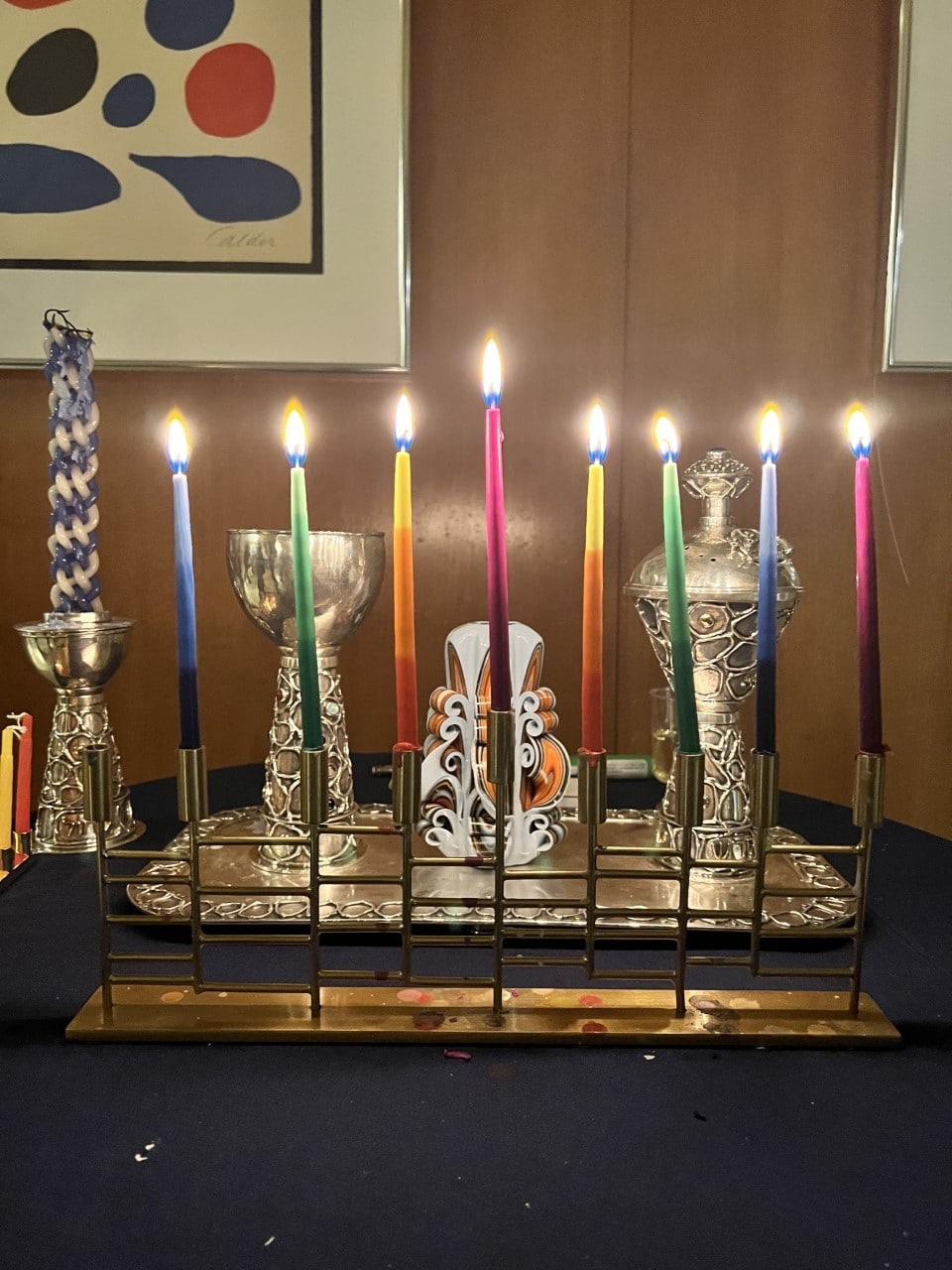 Hanukkah menorah with candles in rainbow colors