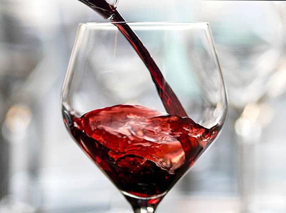 red wine being poured into a glass