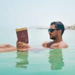 Man reading a book while floating in the Dead Sea