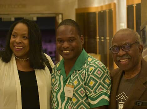Black woman and two Black men stand outside the Sanctuary
