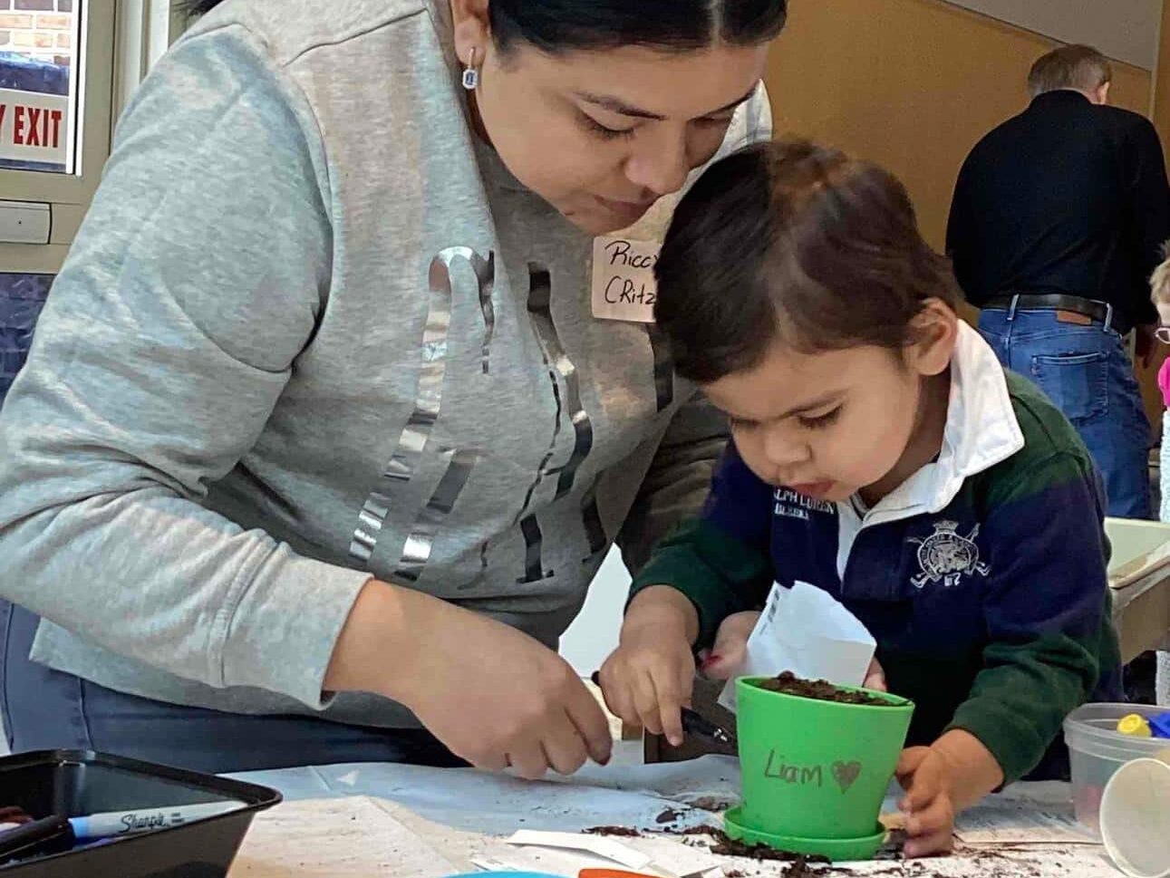 Latina mother and toddler child work on an art project