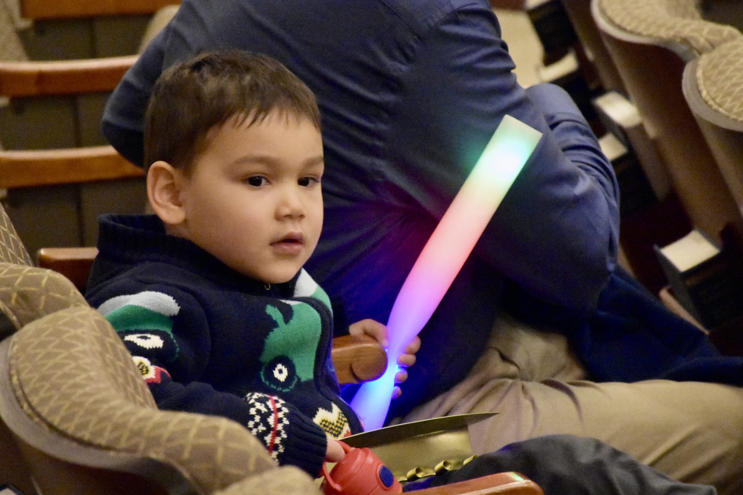 Young child with a glowing stick for shabbat hanukkah 2023