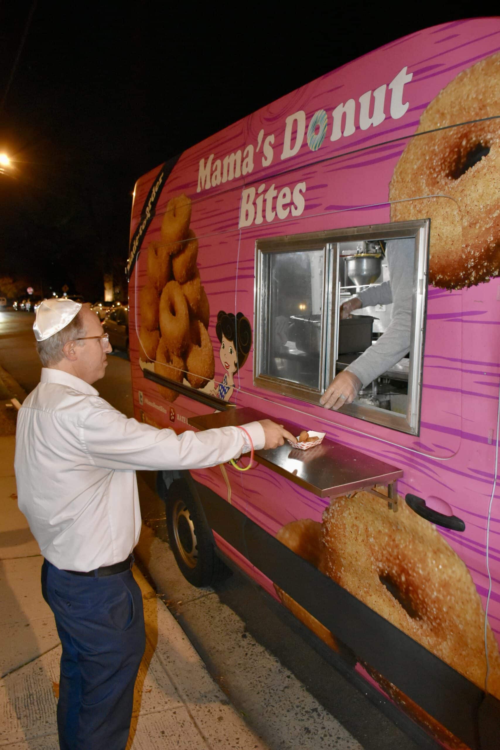 Customer gets donuts from Mamas DOnut Bites at shabbat hanukkah 2023