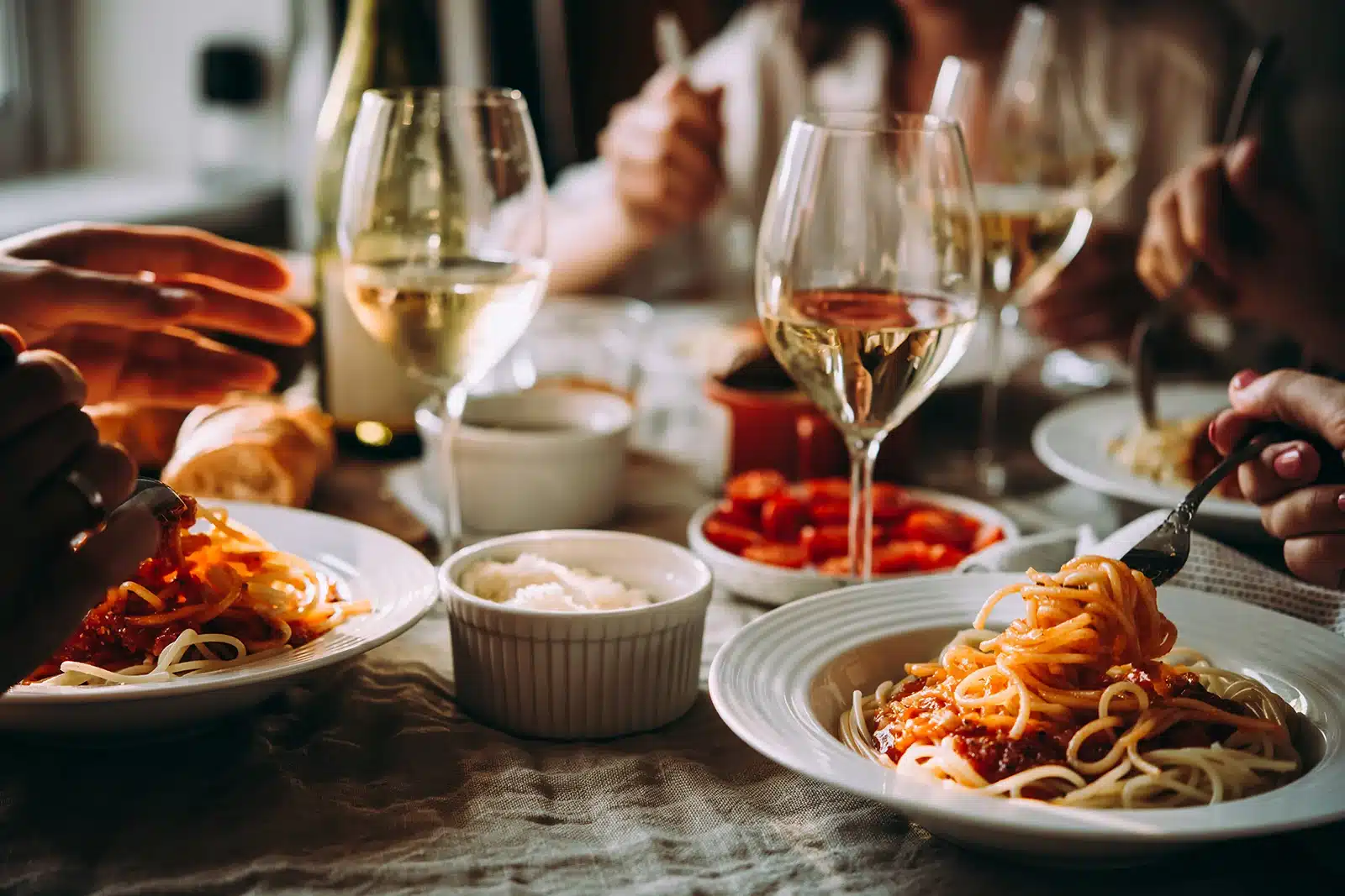 table set with wine and pasta