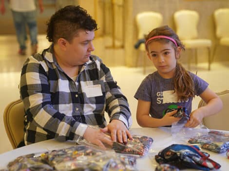 woman and young girl work at a table