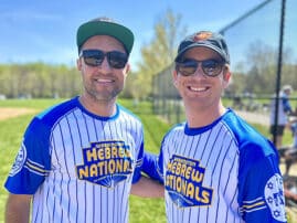 Two men in Hebrew Nationals softball uniforms