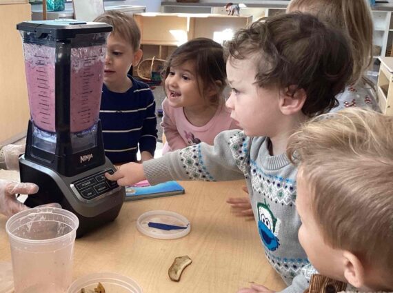 Group of children operating a blender