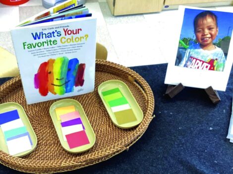 paint palettes on a table with a photo of a child