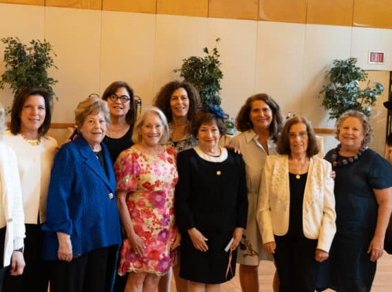 Women of WHC smiling at Luncheon event for Miss Manners
