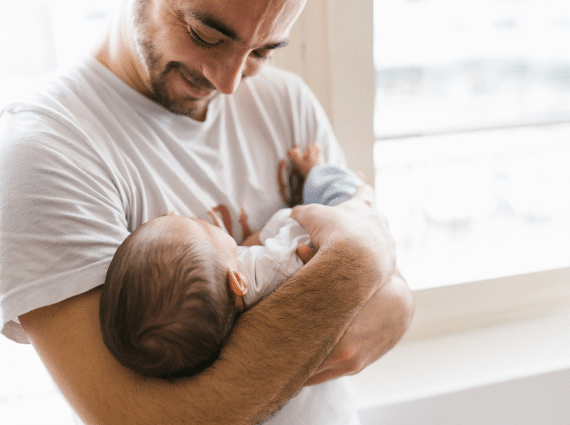 Dad holding baby - New Dads Group